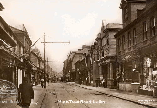 High Town image from a postcard dating between 1912 and 1924. Sepia with no cars and the original building, viewed from the Midland Road upwards.